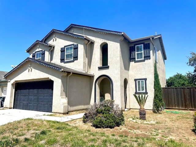 5148 W Pine Ave, Fresno, CA 93722 - view of front of house with stucco siding, fence, and driveway