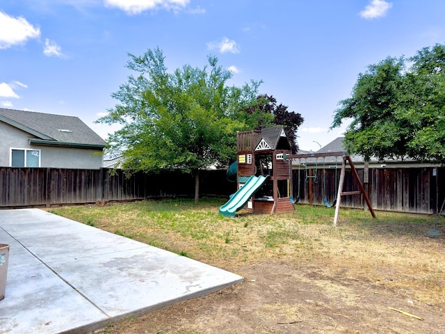 5148 W Pine Ave, Fresno, CA 93722 - view of playground featuring a patio area, a fenced backyard, and a yard