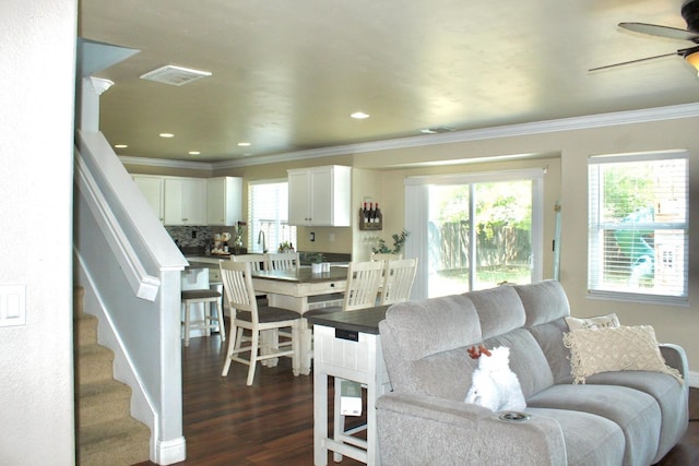 5148 W Pine Ave, Fresno, CA 93722 - living area featuring stairway, dark wood-style floors, visible vents, ornamental molding, and ceiling fan