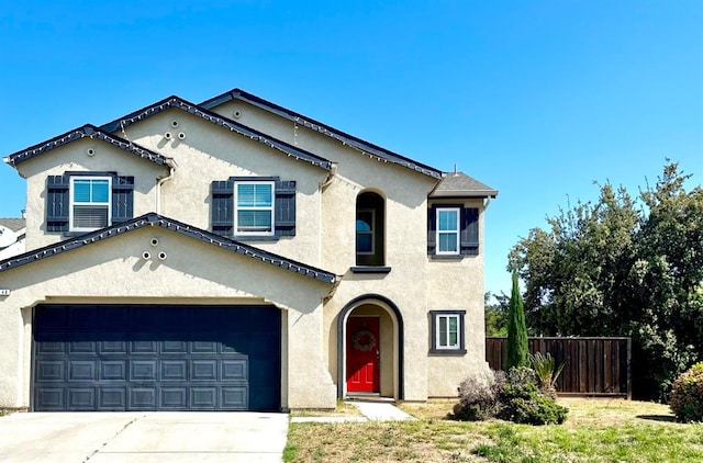5148 W Pine Ave, Fresno, CA 93722 - mediterranean / spanish home with fence, an attached garage, stucco siding, and concrete driveway