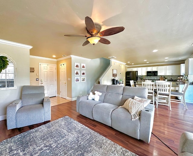 5148 W Pine Ave, Fresno, CA 93722 - living room with stairway, ceiling fan, light wood finished floors, ornamental molding, and recessed lighting