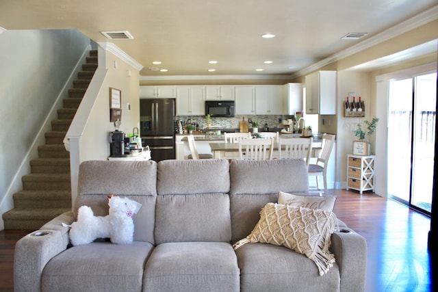 5148 W Pine Ave, Fresno, CA 93722 - living room featuring stairs, ornamental molding, wood finished floors, and visible vents