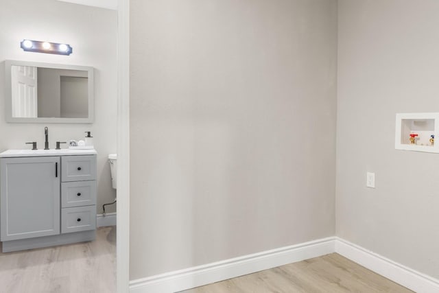 3659 Mono St, Fresno, CA 93702 - laundry room featuring light wood-style flooring and baseboards