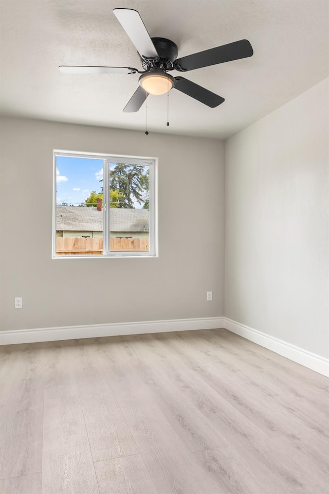 3659 Mono St, Fresno, CA 93702 - empty room with light wood finished floors and ceiling fan