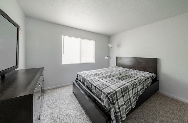 bedroom with baseboards and light colored carpet