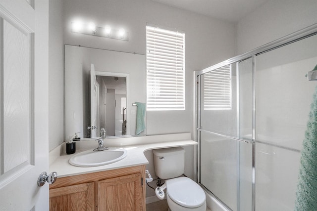 full bathroom featuring vanity, toilet, and a stall shower