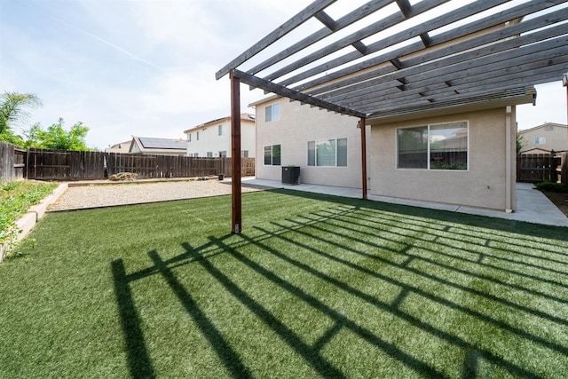 back of house featuring a pergola, a lawn, a fenced backyard, a patio, and stucco siding