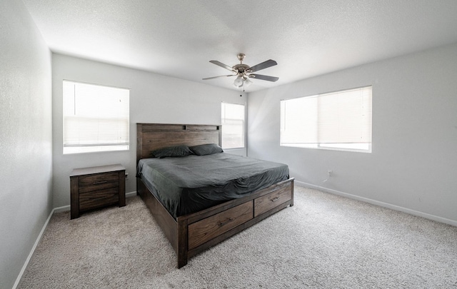 bedroom featuring baseboards, a ceiling fan, and carpet flooring