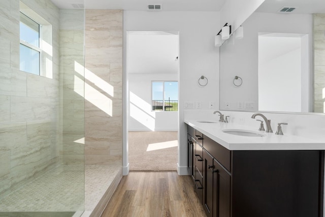 full bathroom featuring wood finished floors, visible vents, and a sink