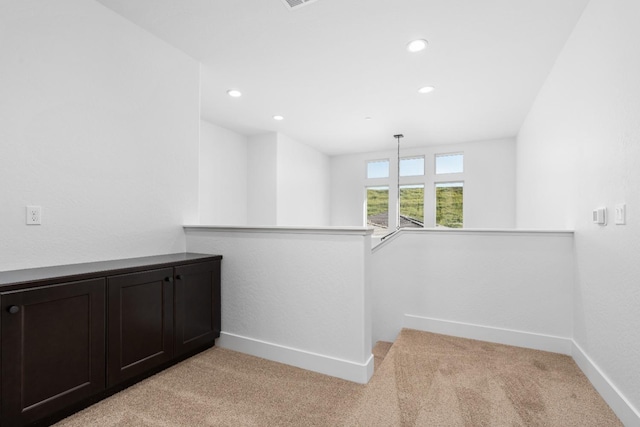 unfurnished room with recessed lighting, baseboards, and light colored carpet