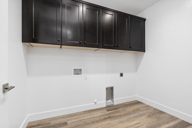 laundry room with hookup for an electric dryer, light wood-type flooring, cabinet space, gas dryer hookup, and washer hookup