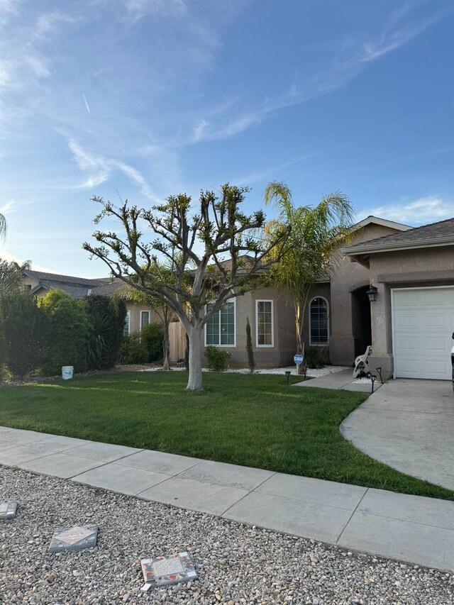 5357 E Burns, Fresno, CA 93725 - ranch-style home with an attached garage, driveway, a front yard, and stucco siding