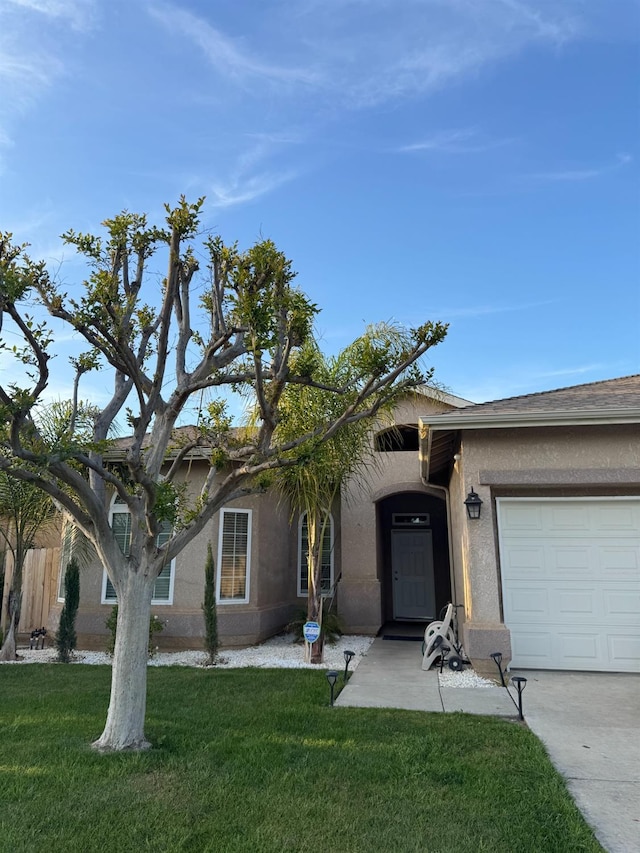 5357 E Burns, Fresno, CA 93725 - single story home with stucco siding, a front lawn, fence, and an attached garage