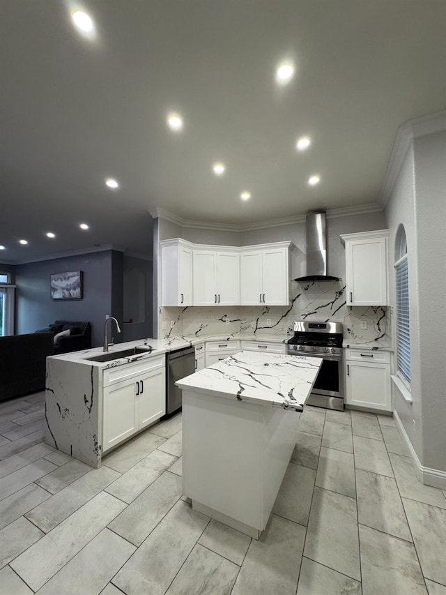 5357 E Burns, Fresno, CA 93725 - kitchen featuring appliances with stainless steel finishes, wall chimney range hood, ornamental molding, a peninsula, and backsplash