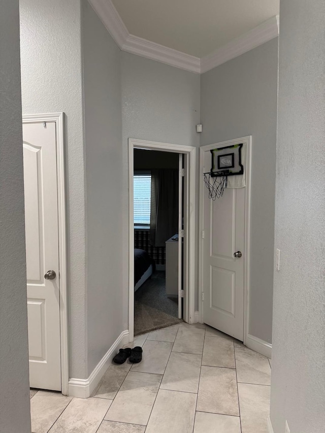 5357 E Burns, Fresno, CA 93725 - hallway with light tile patterned flooring, a textured wall, crown molding, and baseboards
