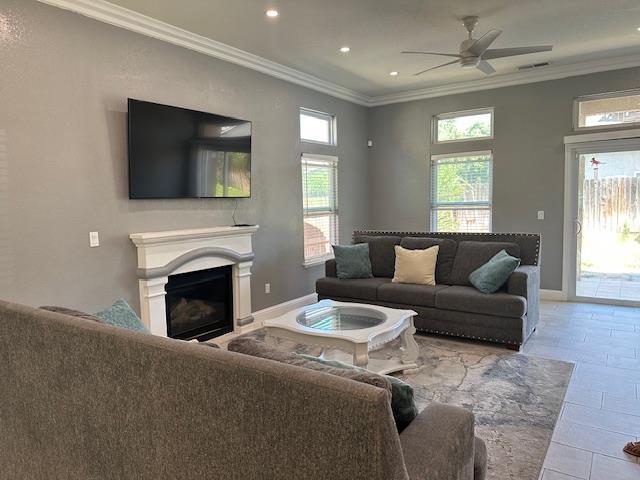 5357 E Burns, Fresno, CA 93725 - living area featuring ceiling fan, a fireplace, recessed lighting, ornamental molding, and tile patterned flooring