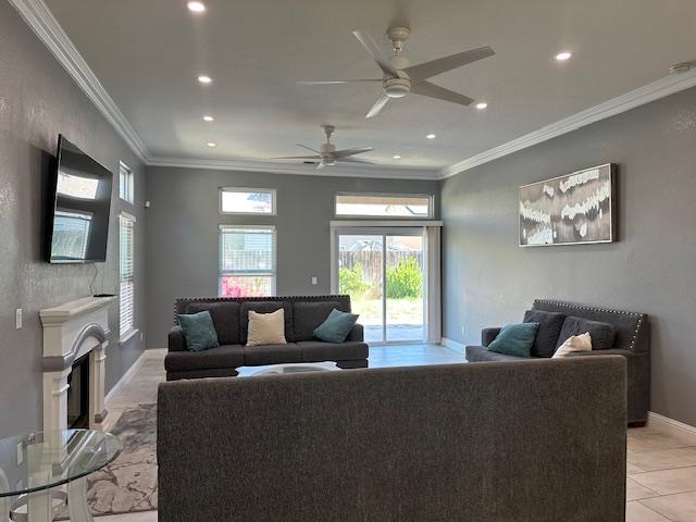 5357 E Burns, Fresno, CA 93725 - living area featuring recessed lighting, ceiling fan, a fireplace with raised hearth, ornamental molding, and light tile patterned flooring