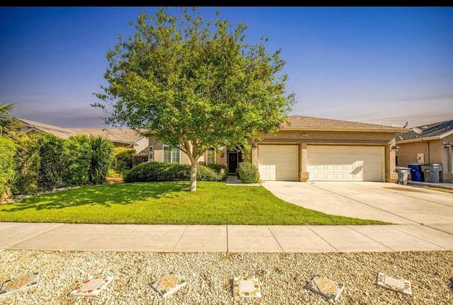 5357 E Burns, Fresno, CA 93725 - view of front of home featuring an attached garage, driveway, a front yard, and stucco siding