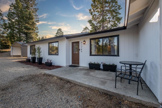 exterior entry at dusk with a patio area