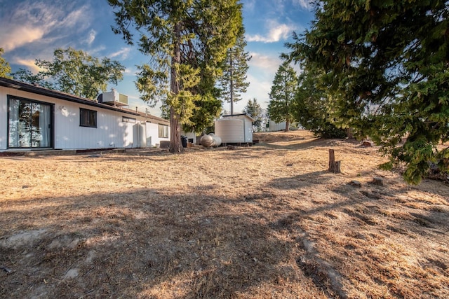 view of yard featuring an outdoor structure, central air condition unit, and a shed