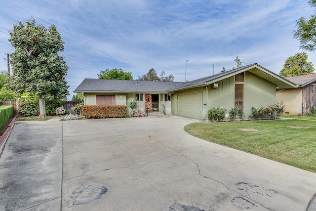 ranch-style house with a garage, fence, a front yard, and concrete driveway