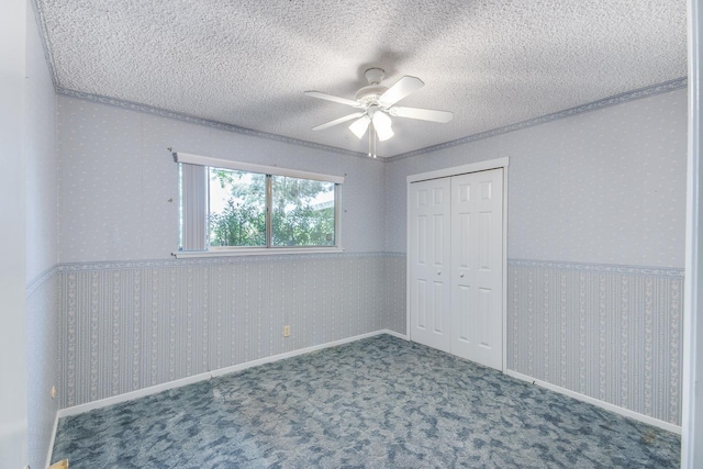 unfurnished bedroom featuring wallpapered walls, a textured ceiling, and crown molding