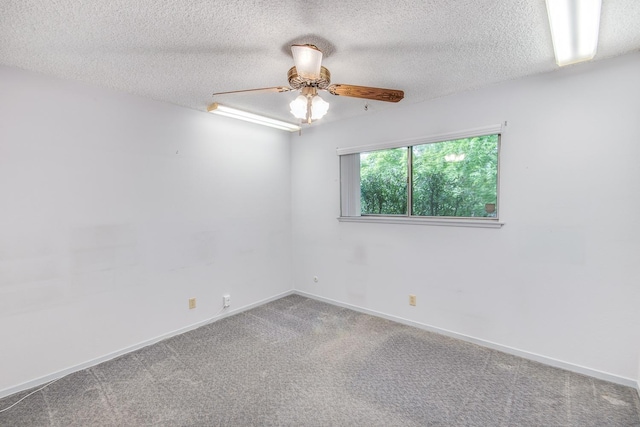 unfurnished room with carpet, a textured ceiling, baseboards, and ceiling fan
