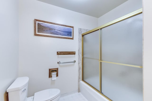 full bath featuring toilet and bath / shower combo with glass door