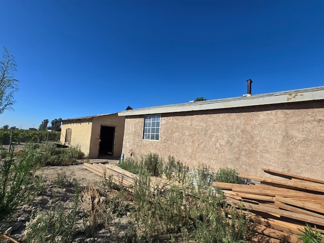 12441 S Henderson Rd, Caruthers, CA 93609 - rear view of house featuring stucco siding and fence