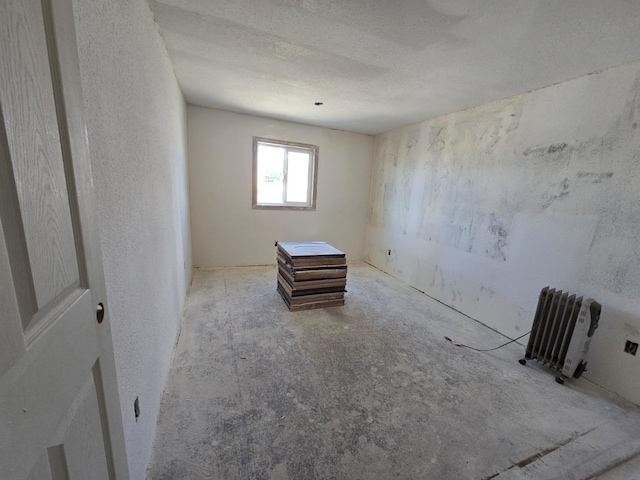 12441 S Henderson Rd, Caruthers, CA 93609 - unfurnished room featuring a textured wall and radiator
