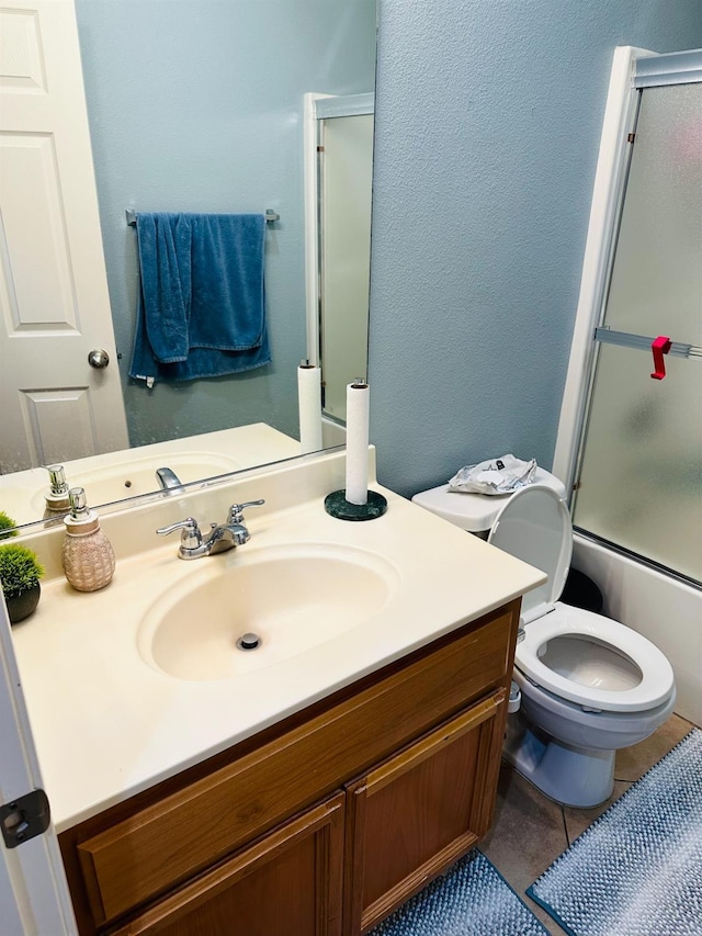 2148 S Villa Ave, Fresno, CA 93727 - full bathroom featuring tile patterned floors, vanity, combined bath / shower with glass door, and toilet