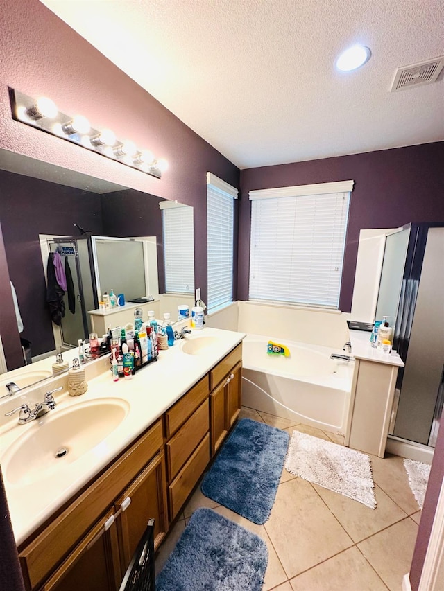 2148 S Villa Ave, Fresno, CA 93727 - bathroom with a textured ceiling, a sink, visible vents, a shower stall, and a garden tub