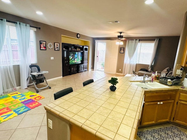 2148 S Villa Ave, Fresno, CA 93727 - interior space with ceiling fan, baseboards, a sink, and light tile patterned floors