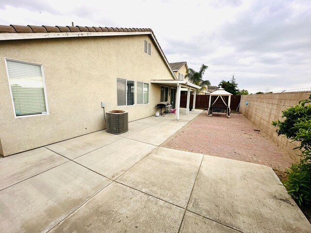 2148 S Villa Ave, Fresno, CA 93727 - back of house with central AC, a fenced backyard, a patio, and stucco siding
