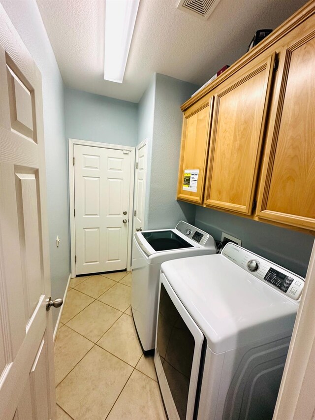2148 S Villa Ave, Fresno, CA 93727 - laundry room with cabinet space, a textured ceiling, visible vents, and separate washer and dryer