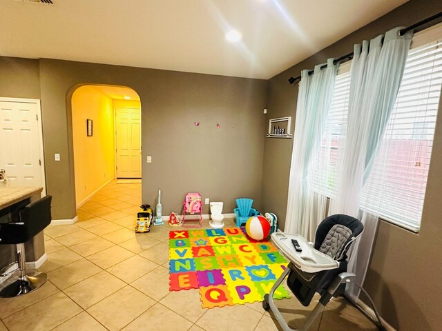 2148 S Villa Ave, Fresno, CA 93727 - game room with baseboards, arched walkways, and light tile patterned floors