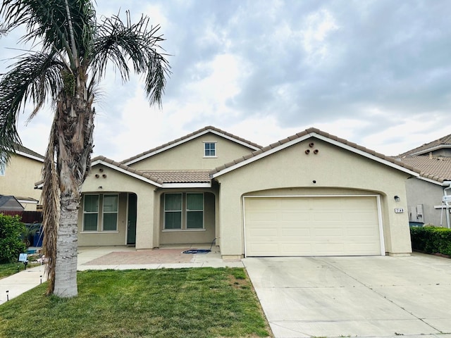 2148 S Villa Ave, Fresno, CA 93727 - single story home featuring concrete driveway, an attached garage, a tile roof, stucco siding, and a front yard