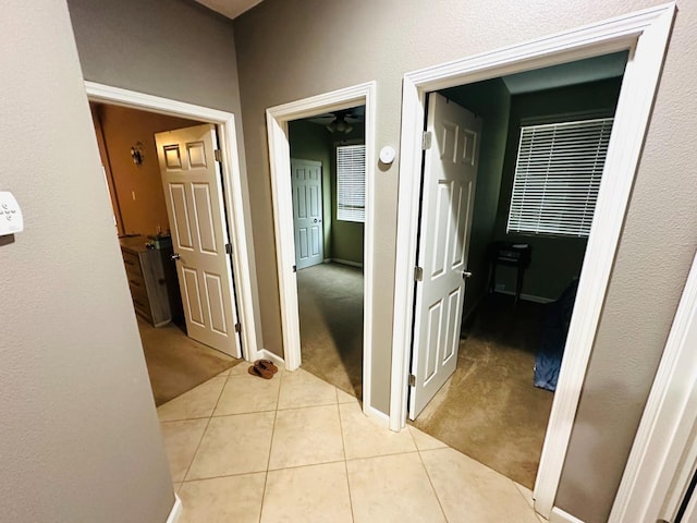2148 S Villa Ave, Fresno, CA 93727 - hall with light tile patterned floors, baseboards, and light colored carpet