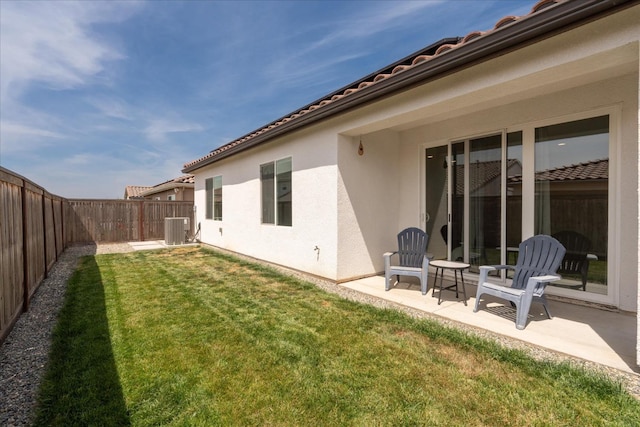 640 Wood Crest Ave, Madera, CA 93636 - rear view of house with a fenced backyard, stucco siding, a patio area, a lawn, and central air condition unit