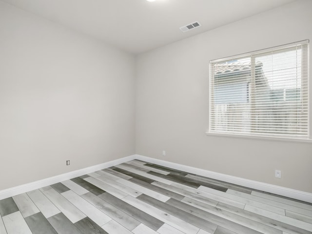 1026 E Carnoustie Ave, Fresno, CA 93730 - spare room featuring visible vents, baseboards, and wood finished floors