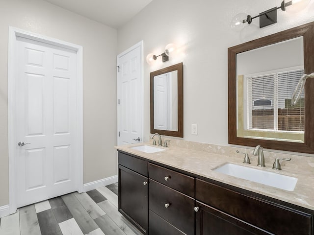1026 E Carnoustie Ave, Fresno, CA 93730 - full bathroom featuring double vanity, a sink, and baseboards