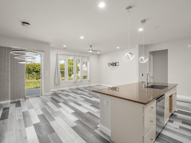 1026 E Carnoustie Ave, Fresno, CA 93730 - kitchen with a sink, open floor plan, dark stone counters, recessed lighting, and an island with sink