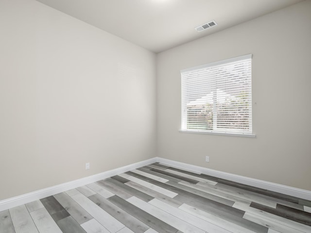 1026 E Carnoustie Ave, Fresno, CA 93730 - empty room with visible vents, baseboards, and wood finished floors