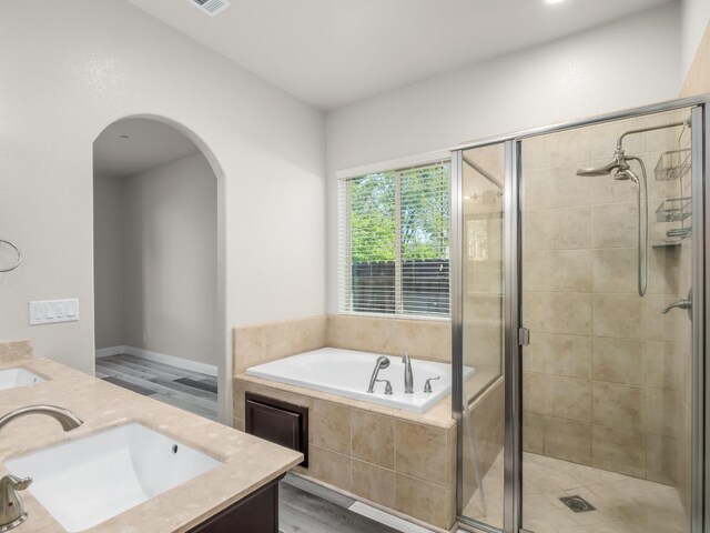 1026 E Carnoustie Ave, Fresno, CA 93730 - bathroom featuring double vanity, a sink, a bath, and a shower stall
