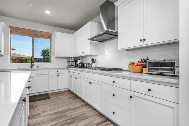 2653 Vermont Ave, Clovis, CA 93619 - kitchen featuring wall chimney exhaust hood, a sink, stainless steel gas cooktop, decorative backsplash, and recessed lighting