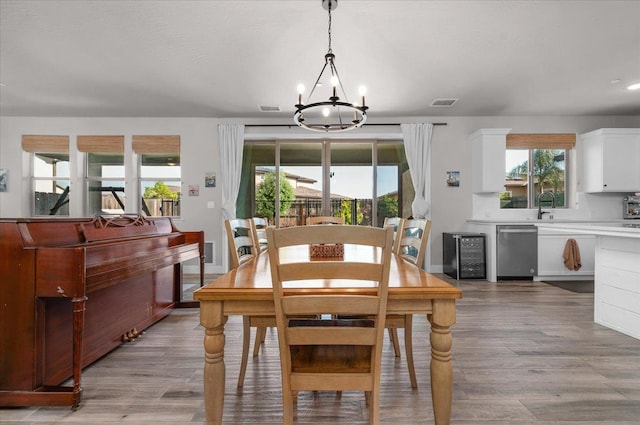 2653 Vermont Ave, Clovis, CA 93619 - dining room featuring a chandelier, light wood finished floors, wine cooler, and baseboards