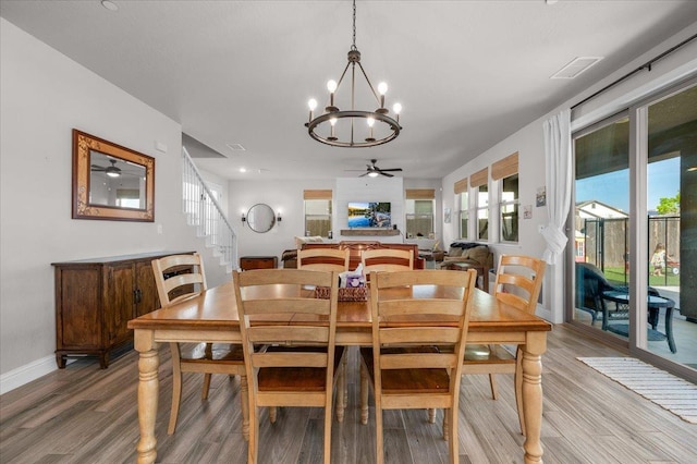 2653 Vermont Ave, Clovis, CA 93619 - dining room with a chandelier, light wood-type flooring, and plenty of natural light