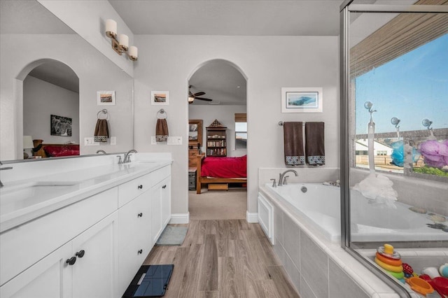 2653 Vermont Ave, Clovis, CA 93619 - ensuite bathroom with wood finished floors, a ceiling fan, double vanity, and a garden tub