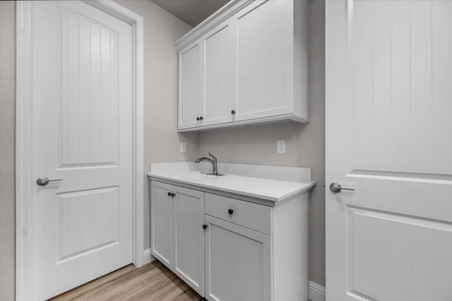 2653 Vermont Ave, Clovis, CA 93619 - laundry room with a sink and light wood-type flooring