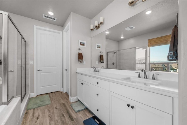 2653 Vermont Ave, Clovis, CA 93619 - full bathroom with wood finished floors, a shower stall, double vanity, and recessed lighting